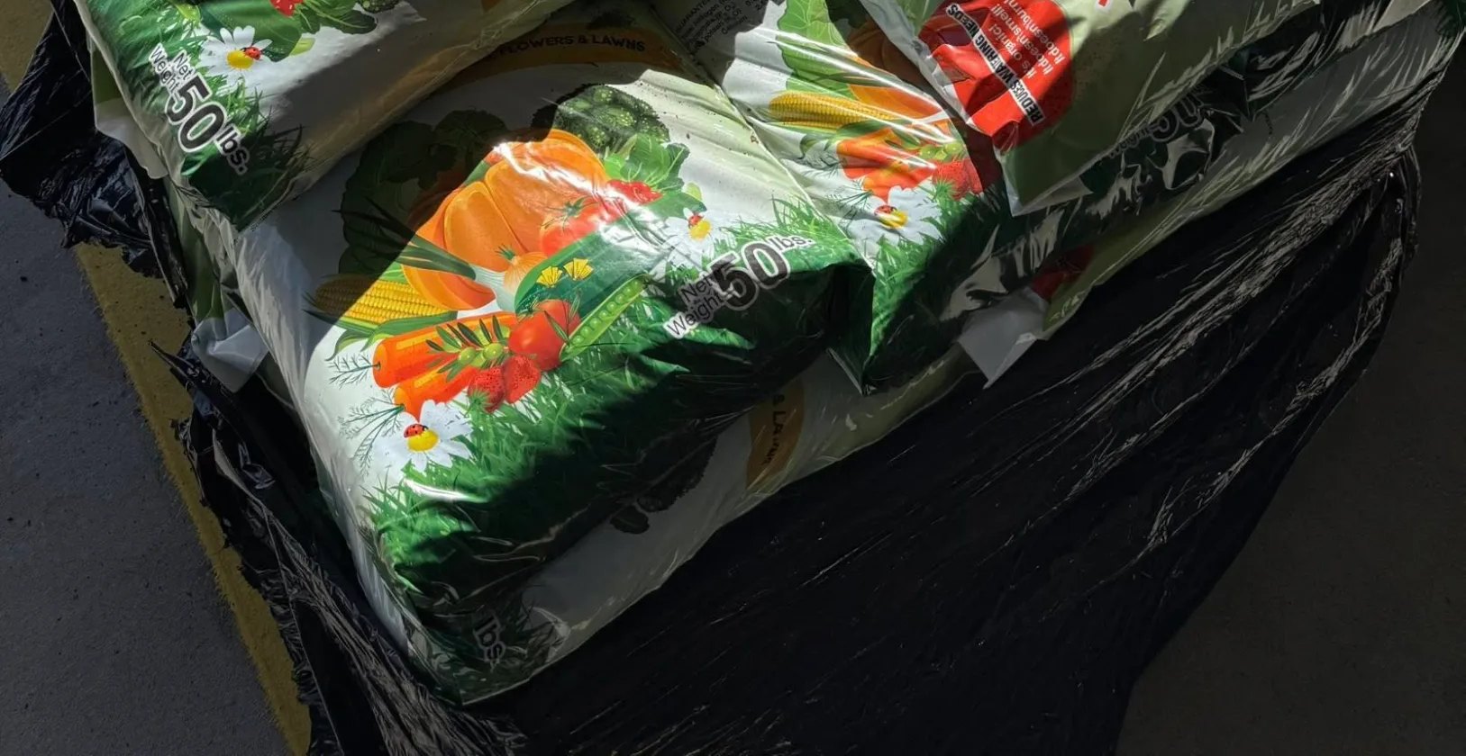 Pallets of bagged compost at a stocking dealer